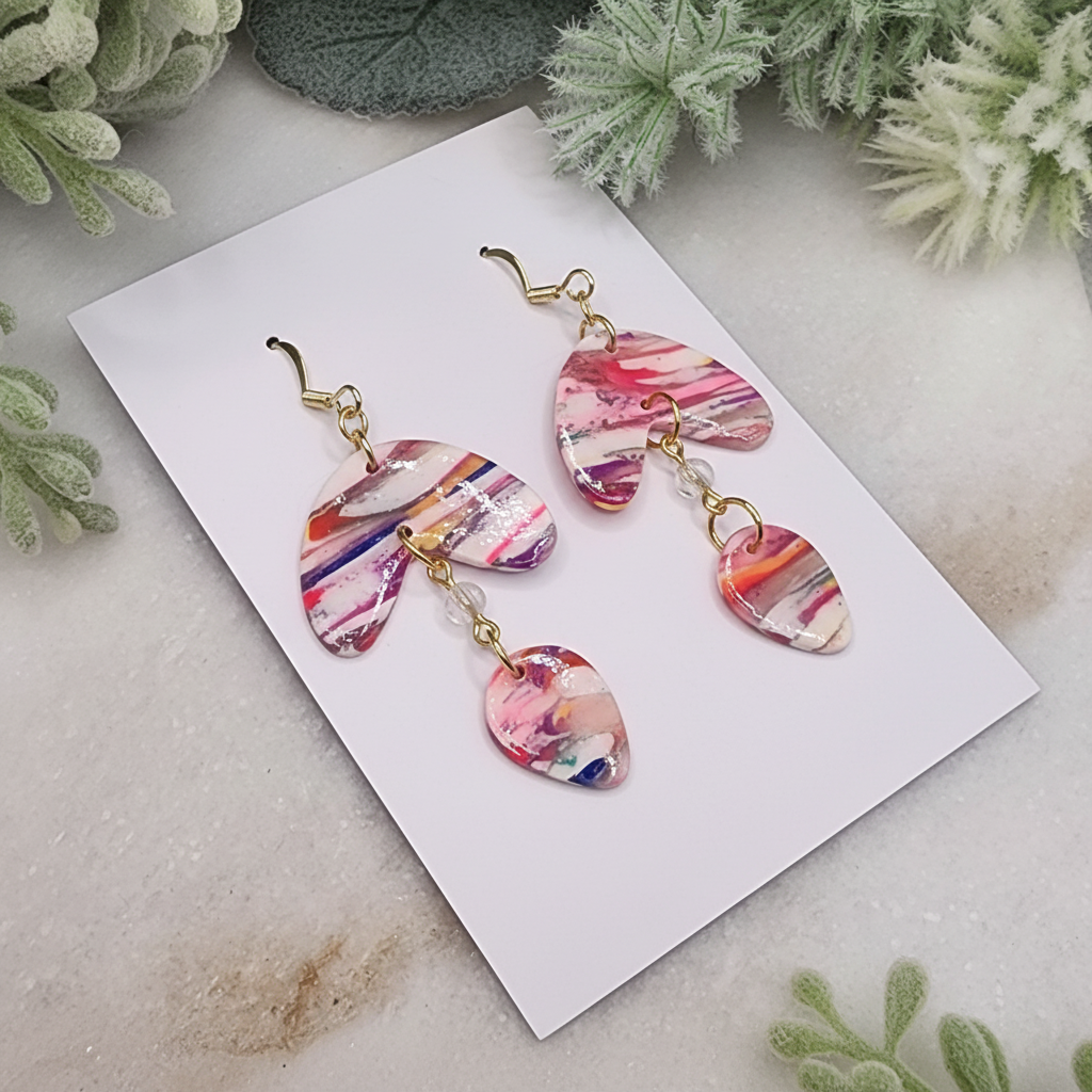 "Handmade polymer clay marble arc drop earrings with pink coral orange striped pattern and gold chain connectors"