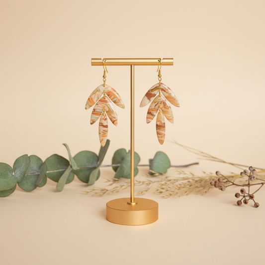 "Handmade polymer clay agate statement earrings with layered marbled leaves in cream, peach, and coral"