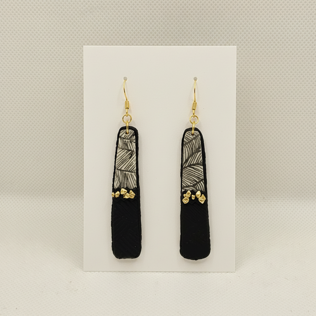andmade black polymer clay bar drop earrings with botanical leaf print and gold nuggets on plain white card, by Crafty Larder NZ