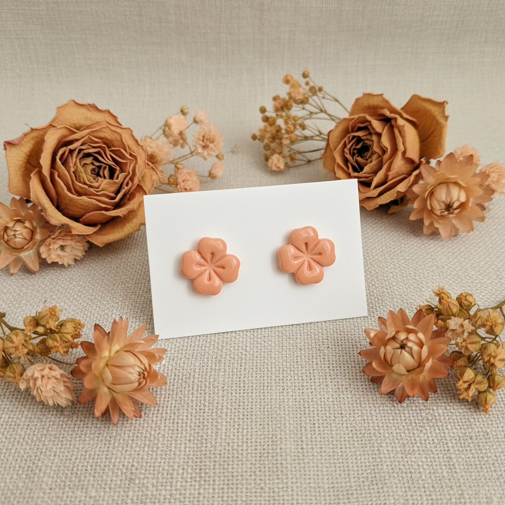 Briar Studs in Brandied Melon — handmade polymer clay 5-petal flower stud earrings with clean etched petal lines and glossy finish, displayed on white card with dried peach roses and apricot botanical styling, handcrafted in New Zealand by Crafty Larder