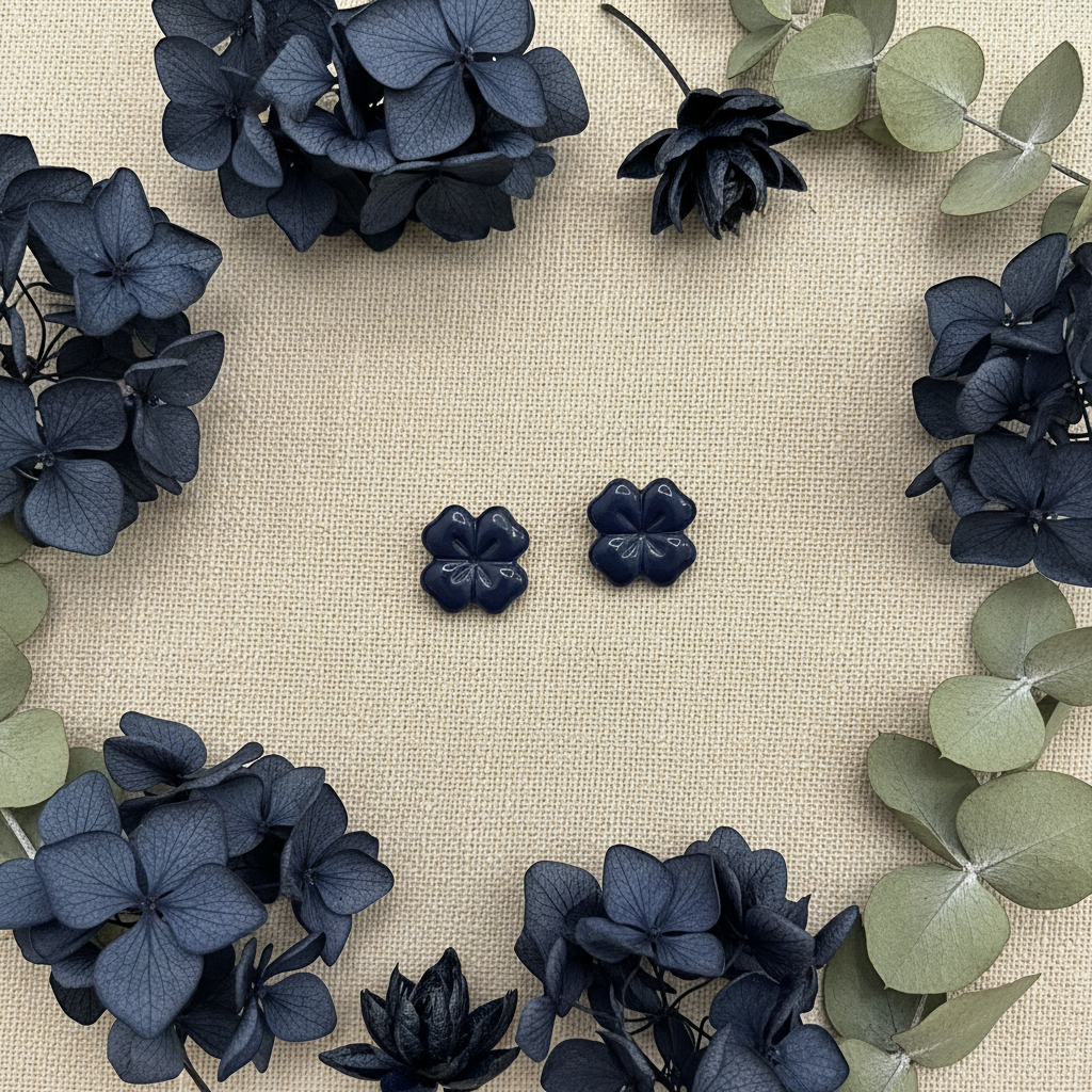 Briar Studs in Crown Blue flat lay with deep blue dried hydrangeas and dark navy botanicals on warm linen, handmade polymer clay earrings from Crafty Larder's Harvest & Dusk Collection