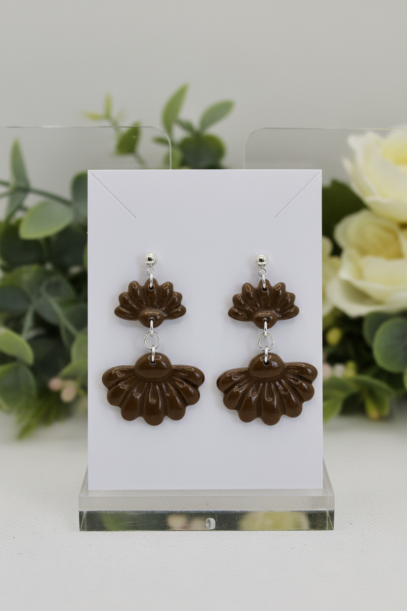 Handmade polymer clay Petal Tier Earrings in Bronze Brown — deep olive-brown two-tiered ruffled flower drops with silver ball stud, displayed on a plain white jewellery card with soft botanical background