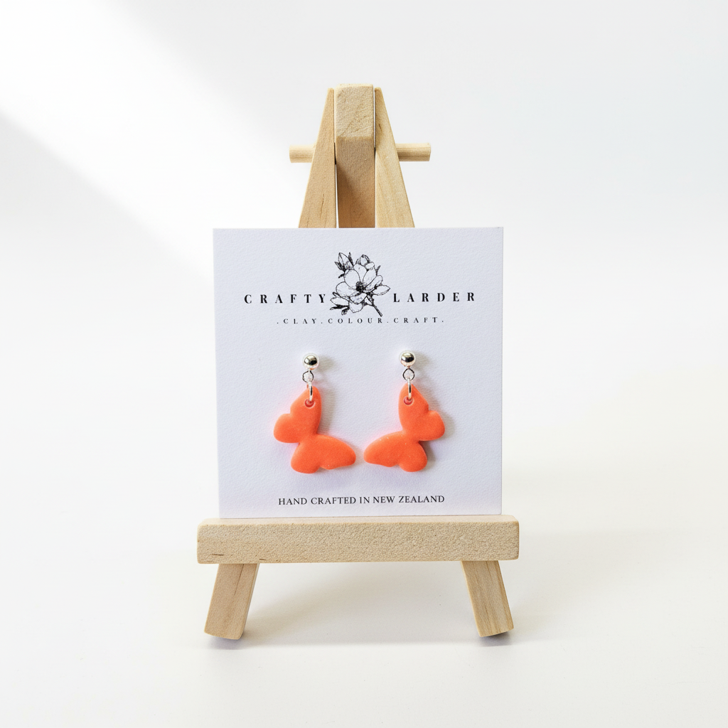 "Bright orange butterfly dangle earrings on Crafty Larder card"