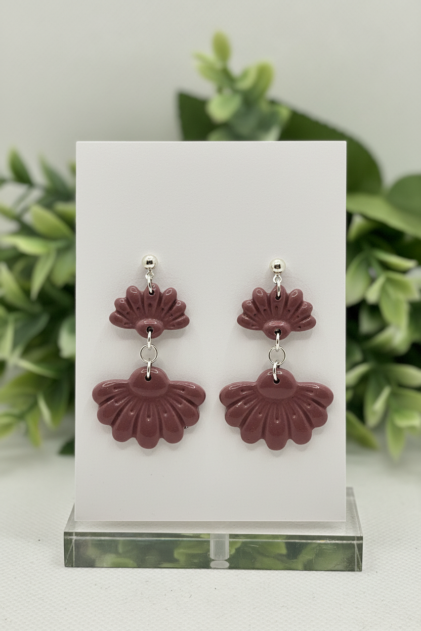 Handmade polymer clay Petal Tier Earrings in Damson — muted dusty plum two-tiered ruffled flower drops with silver ball stud, displayed on a plain white jewellery card with soft botanical background