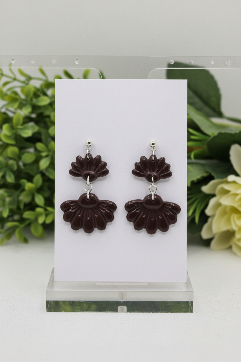 Handmade polymer clay Petal Tier Earrings in French Roast — deep espresso brown two-tiered ruffled flower drops with silver ball stud, displayed on a plain white jewellery card with soft botanical background