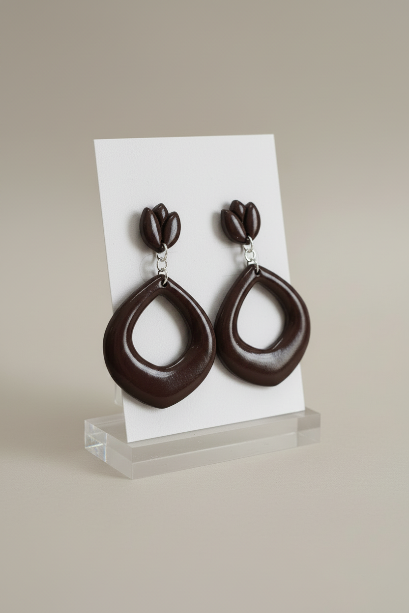 Handmade polymer clay Tulip Loop Earrings in French Roast — deep espresso brown tulip stud top with open teardrop hoop drop, displayed on a plain white jewellery card on a clear acrylic stand
