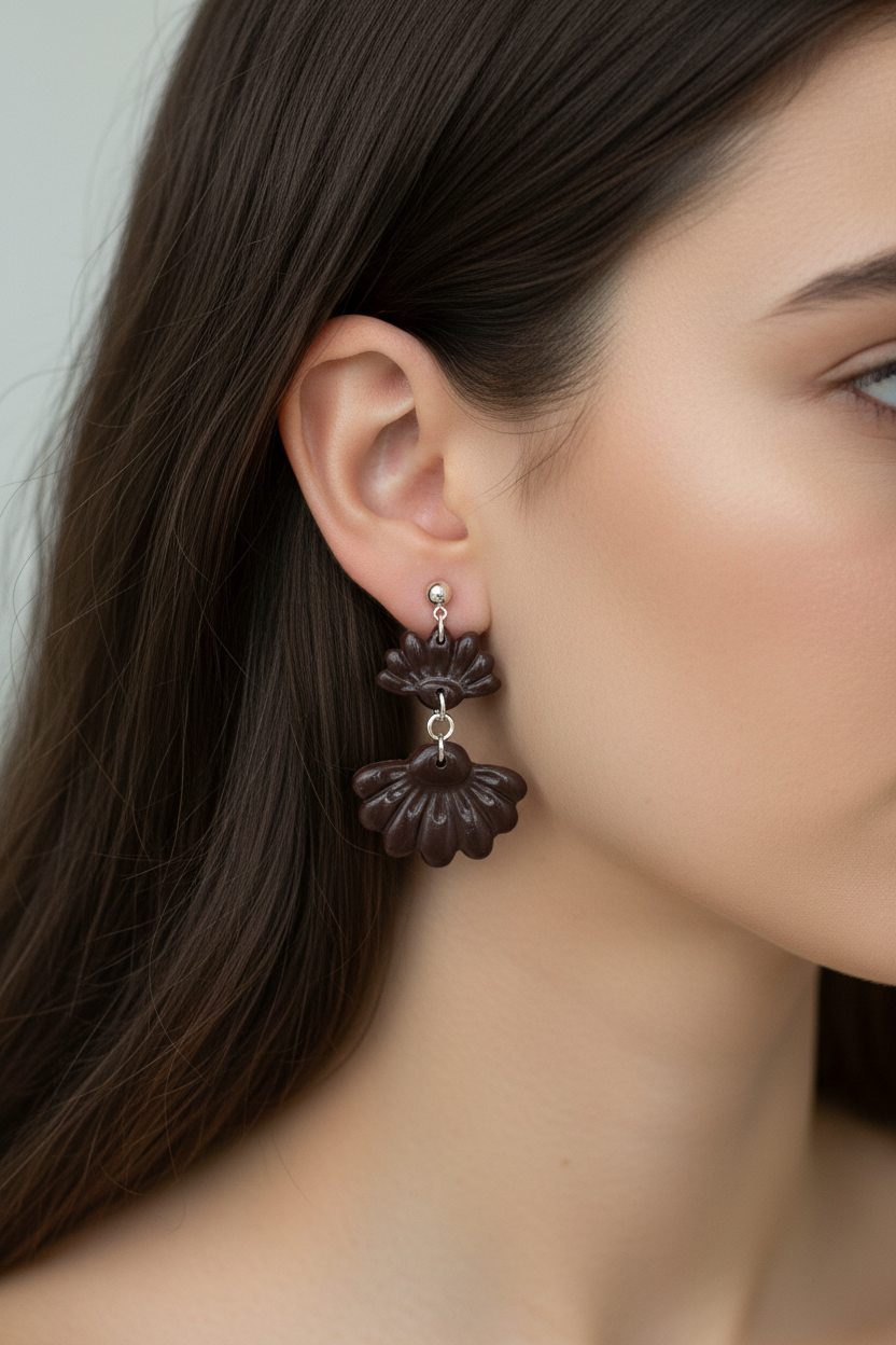 Close up of model wearing Crafty Larder Petal Tier Earrings in French Roast — handmade polymer clay two-tiered ruffled drop earrings in deep espresso brown