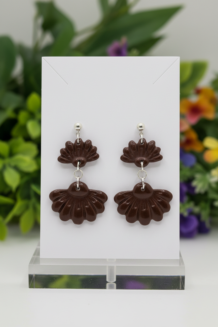 Handmade polymer clay Petal Tier Earrings in Hot Chocolate — deep dark chocolate brown two-tiered ruffled flower drops with silver ball stud, displayed on a plain white jewellery card with soft botanical background