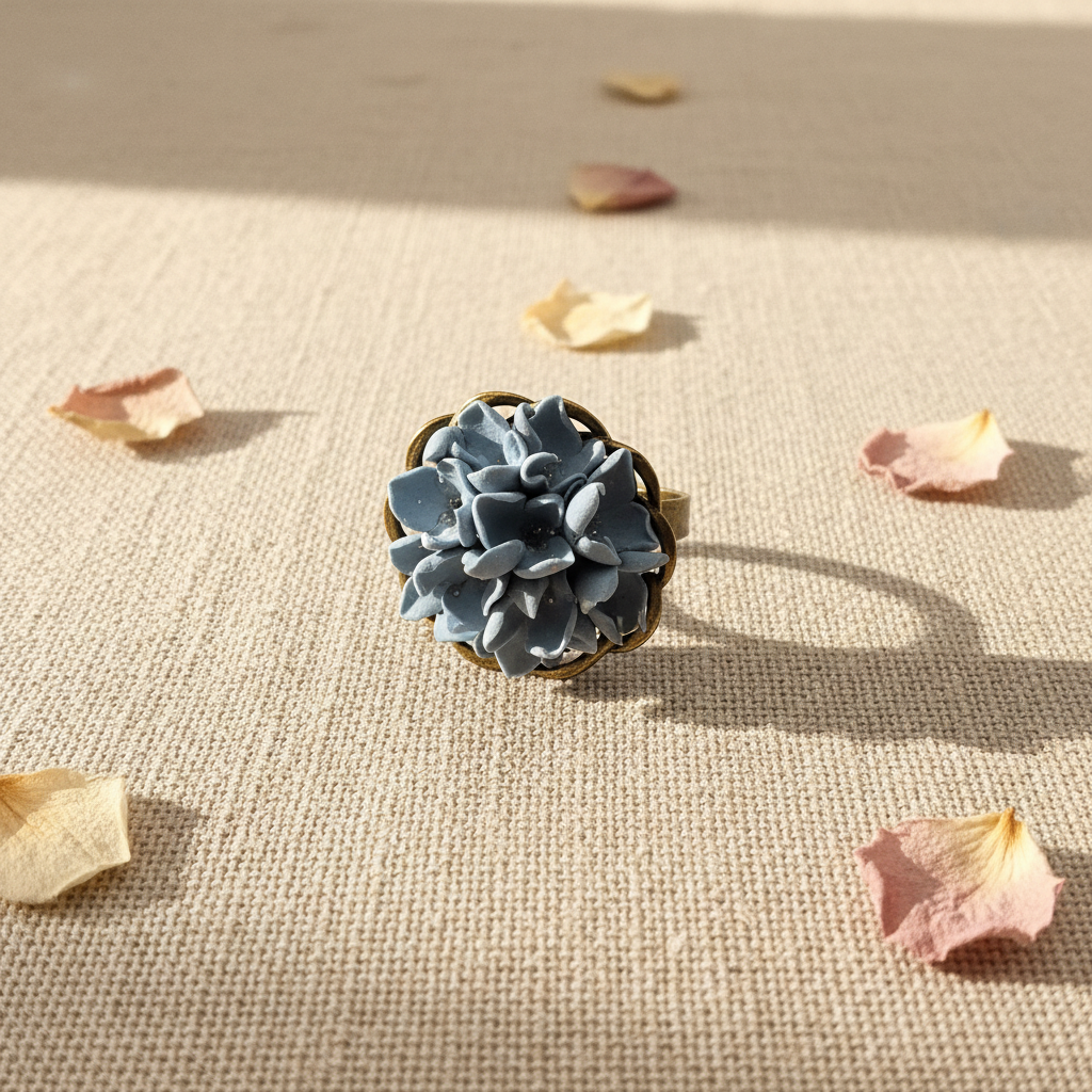 Handmade polymer clay dusty blue flower ring with full floral cluster on linen background, by Crafty Larder NZ
