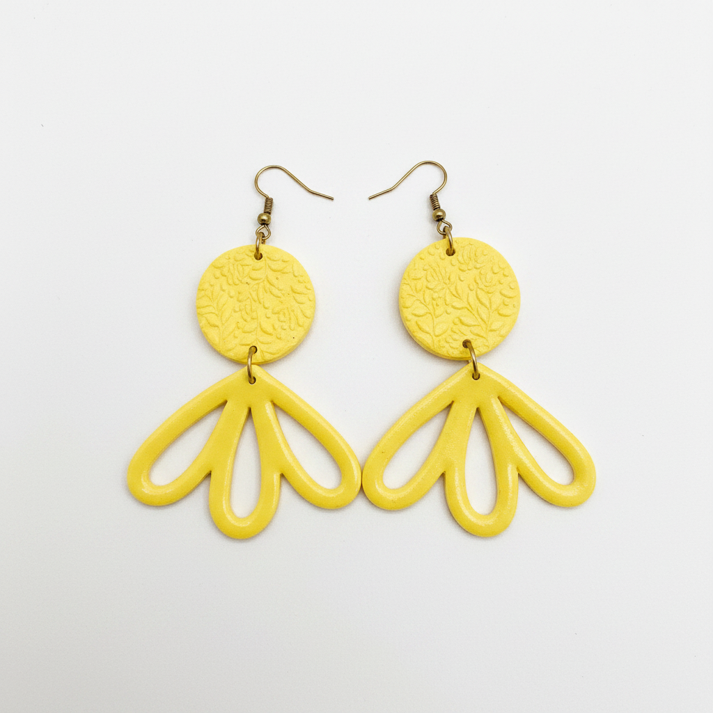 Large handmade yellow polymer clay fan petal drop earrings with textured disc top, flat lay, by Crafty Larder NZ