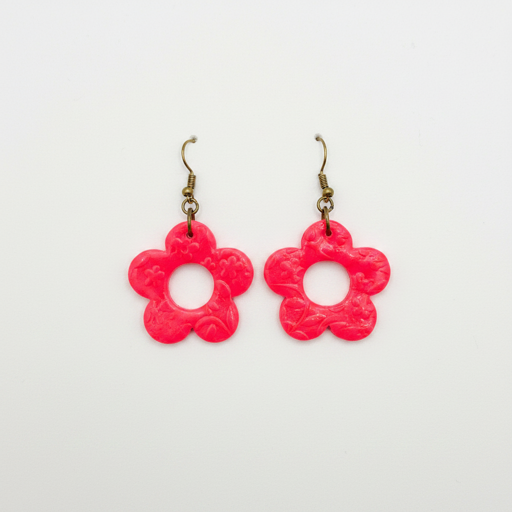 Handmade fluro pink polymer clay open daisy drop earrings with brass hooks on white surface, by Crafty Larder NZ