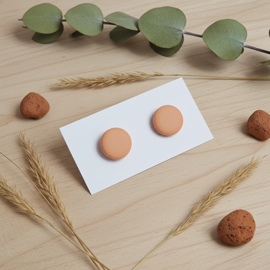 "Handmade polymer clay light terracotta stud earrings in warm peach matte finish"