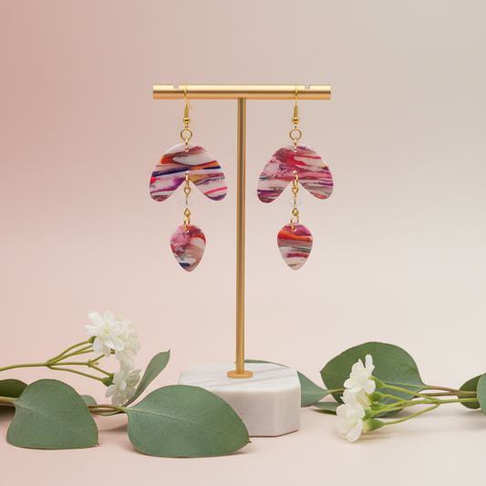  "Handmade polymer clay marble arc drop earrings with pink coral orange striped pattern and gold chain connectors"