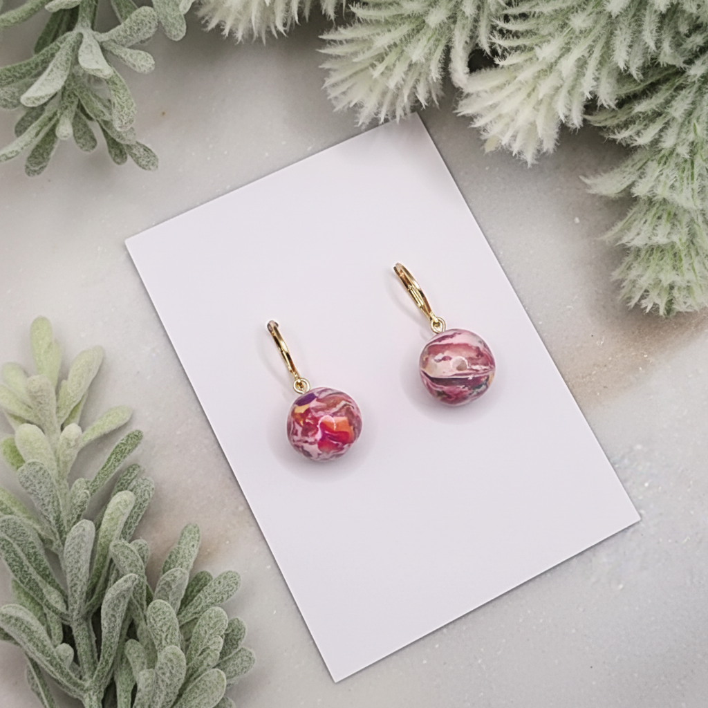 "Handmade polymer clay marble bead huggie earrings with pink coral purple round charms and gold hoops"
