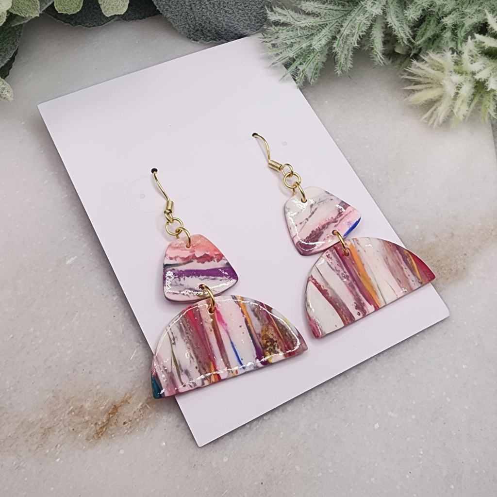 "Handmade polymer clay geometric marble earrings with pink purple coral striped pattern and gold connectors"