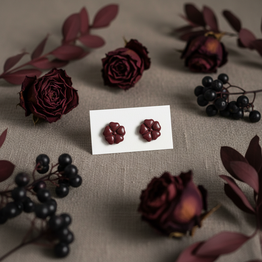 Blossom Studs in Mauve Wine — handmade polymer clay 5-petal flower stud earrings, displayed on white card with rich moody burgundy botanical styling, handcrafted in New Zealand by Crafty Larder