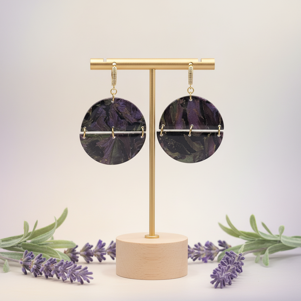  "Handmade polymer clay arc earrings with gold huggie hoop posts and large circular purple/black/green mica shimmer discs with gold arc bar across the middle"