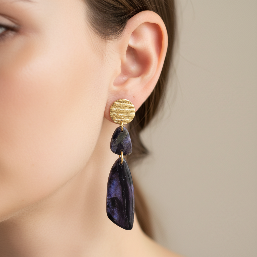 "Handmade polymer clay fob drop earrings with gold textured circular studs and purple/black mica shimmer teardrop dangles"