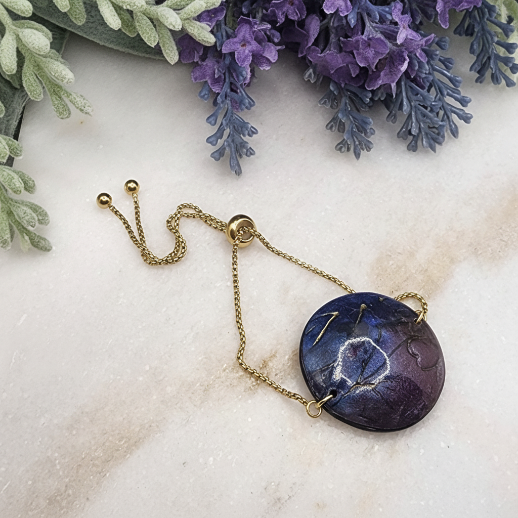  "Handmade polymer clay bracelet with large circular purple/blue mica shimmer pendant with gold marbling on adjustable gold chain"