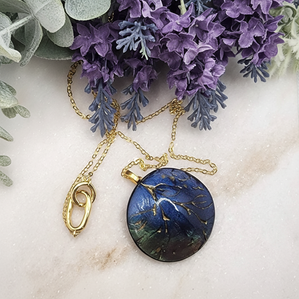  "Handmade polymer clay pendant necklace with large circular blue/purple/green mica shimmer pendant with gold marbling on gold chain"