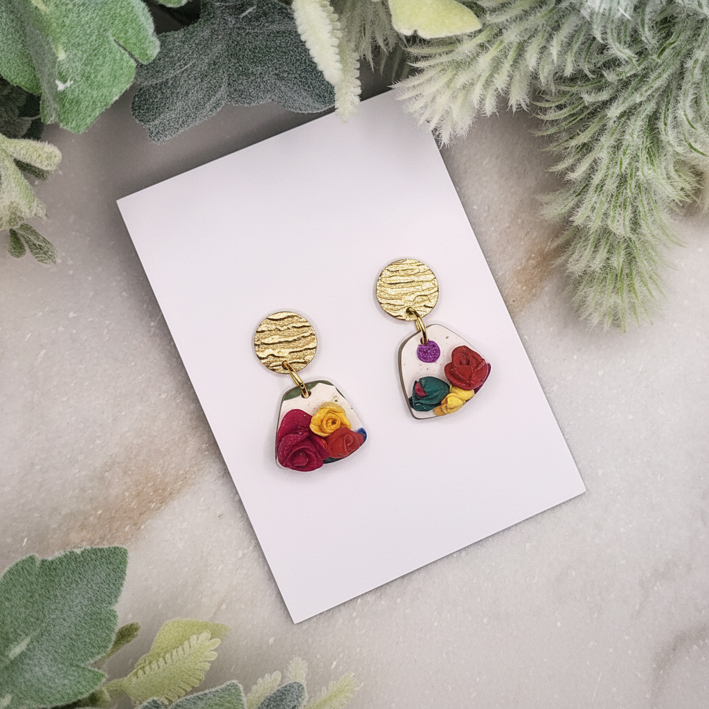  "Handmade polymer clay petite summer bloom earrings with bronze textured circle studs and clear resin heart dangles filled with colorful 3D roses and green leaves"