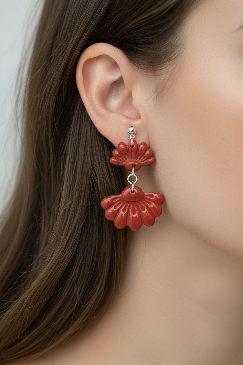 Close up of model wearing Crafty Larder Petal Tier Earrings in Poppy Red — handmade polymer clay two-tiered ruffled drop earrings in warm brick red