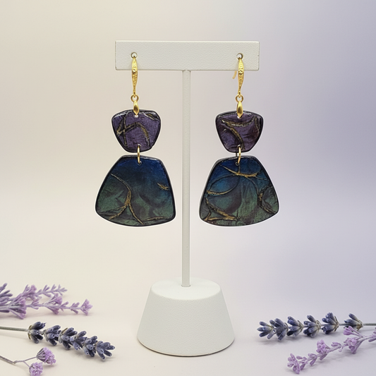 "Handmade polymer clay prism drop earrings with gold textured shepherd hook ear wires and purple/blue/green mica shimmer prism dangles"