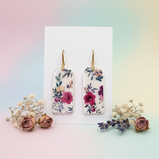 Garden Block Earrings displayed on white card with pastel gradient background and dried roses, baby's breath and lavender styling