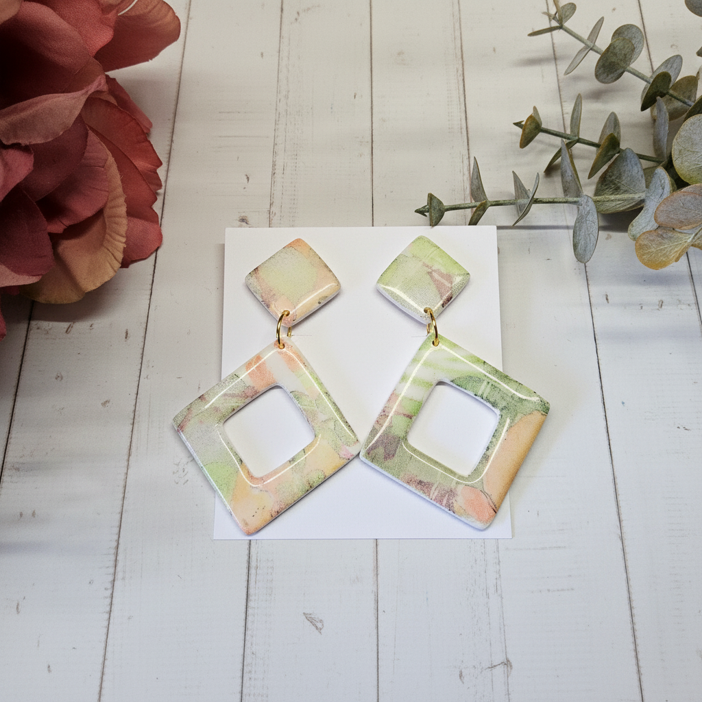 "Handmade polymer clay watercolour floral diamond cutout dangle earrings in soft pastel pink, peach, yellow, green and blue tones"