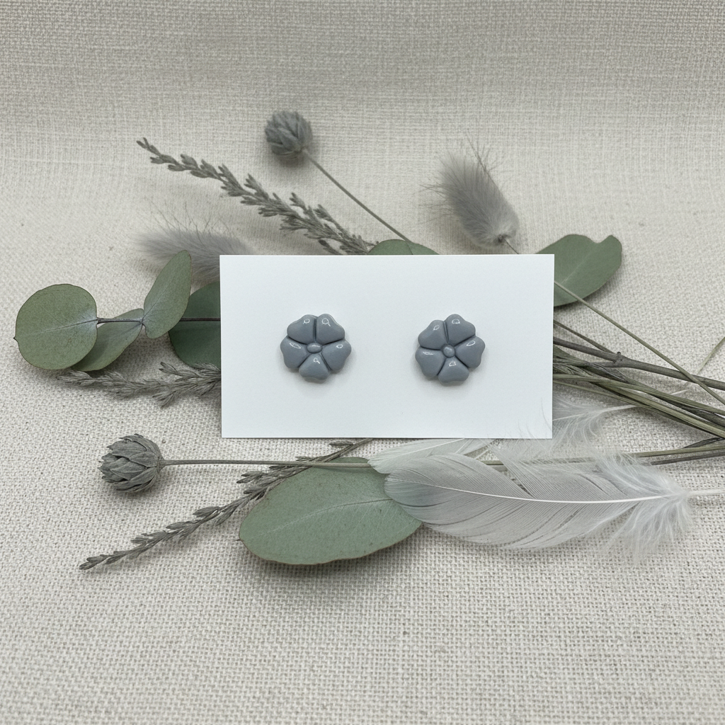 Blossom Studs in Vapor Blue — handmade polymer clay 5-petal flower stud earrings, displayed on white card with soft grey botanical styling, handcrafted in New Zealand by Crafty Larder