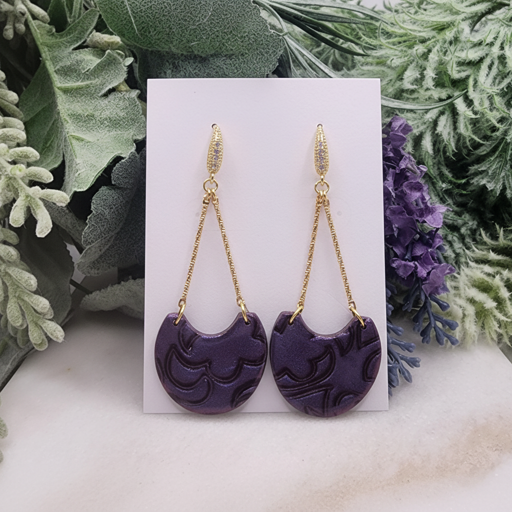 "Handmade polymer clay arc drop earrings with gold textured bar stud posts, long gold chain arcs and deep purple/violet mica shimmer half-moon dangles"
