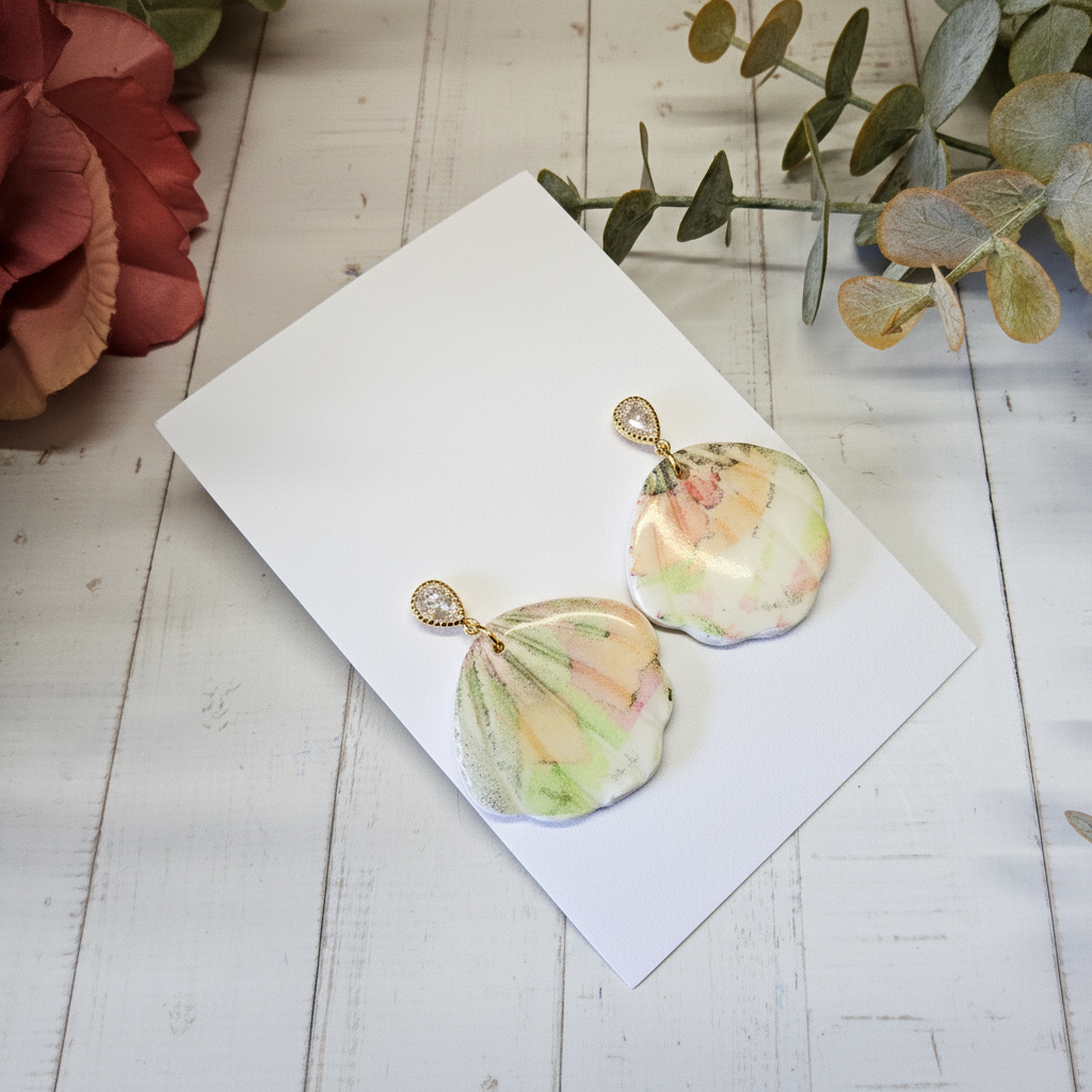 "Handmade polymer clay watercolour floral shell dangle earrings with sparkling cubic zirconia studs in soft pastel pink, peach, yellow and green tones"